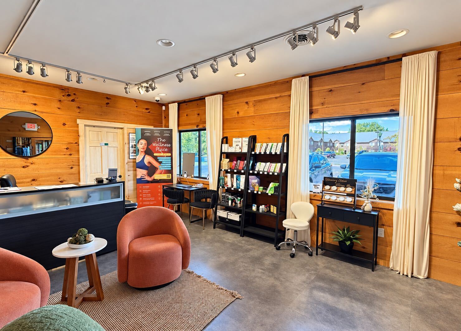 Reception lounge at The Wellness Place with warm pine walls and coral armchairs